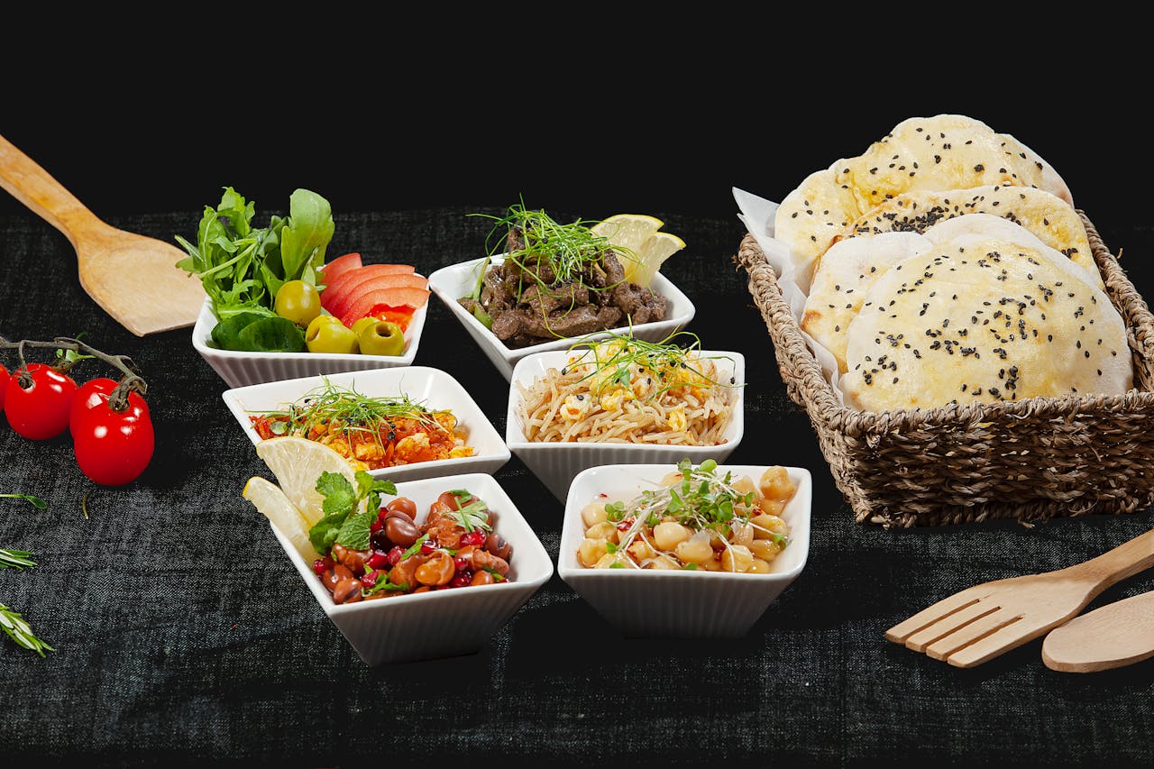 about-us A vibrant mezze platter with Middle Eastern dishes and fresh bread, perfect for sharing.